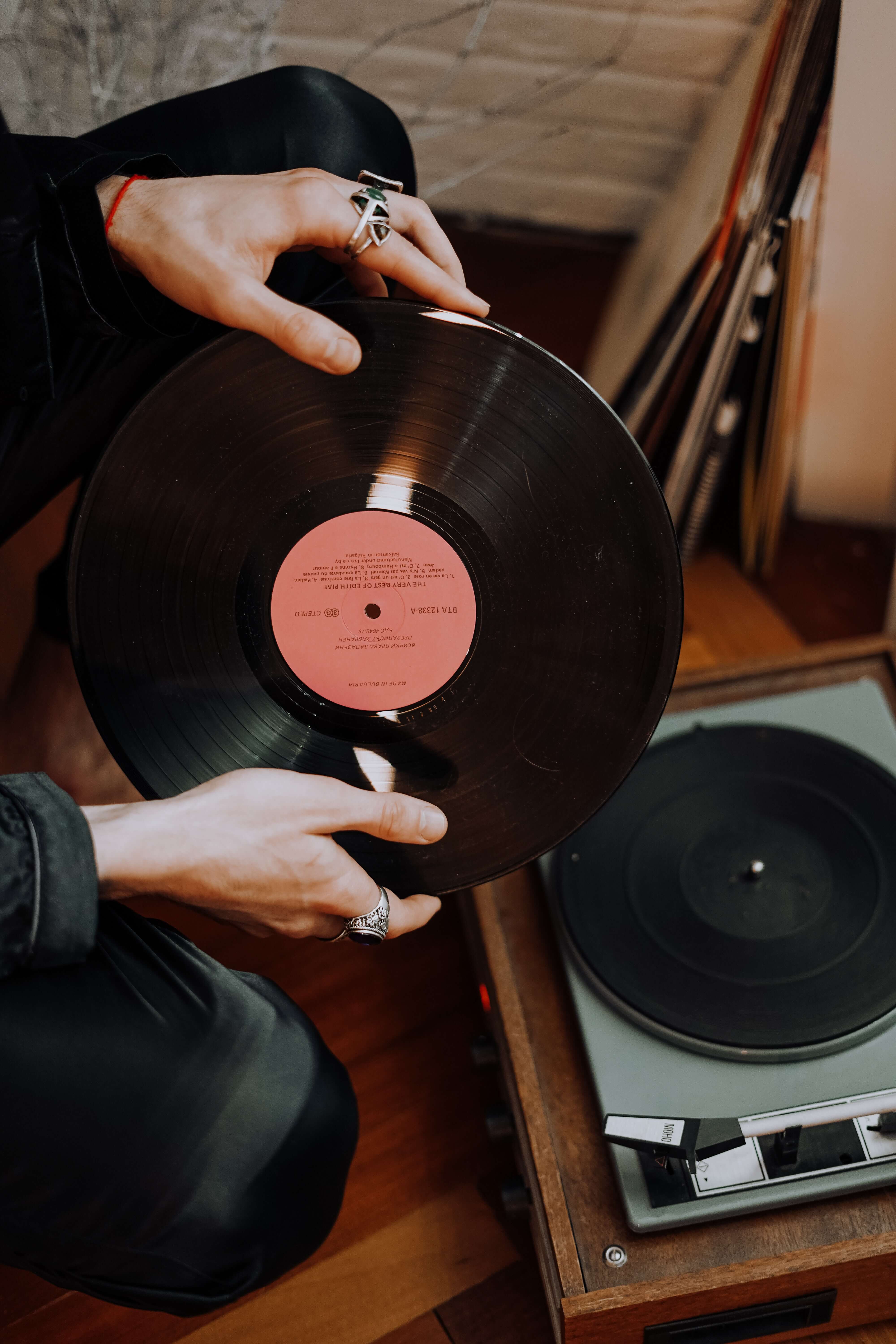 Person putting a vinyl record on